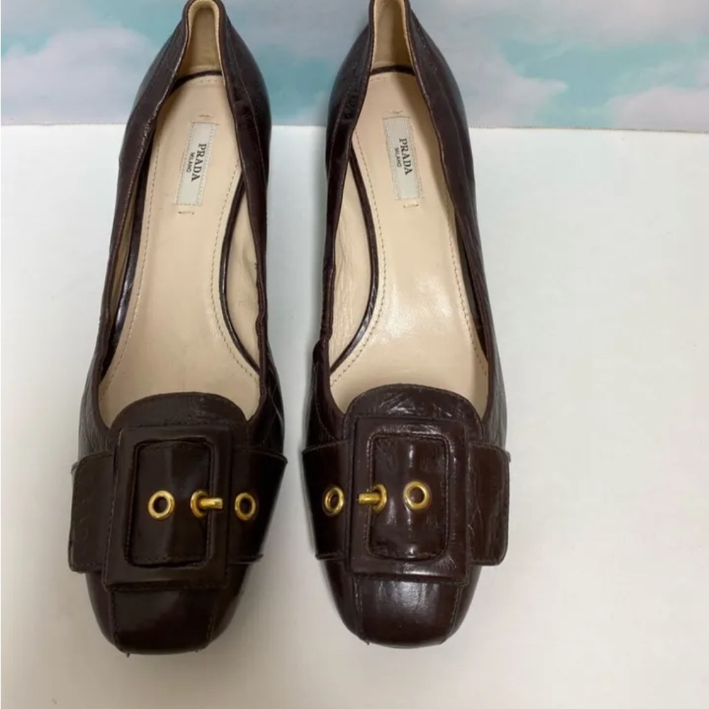 Chocolate leather Prada square-toe loafers with tonal buckle accent at vamps